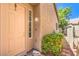 Inviting front door with a welcome stone, trimmed window, and green landscaping at 201 Teller St, Henderson, NV 89074