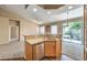 Kitchen with stainless steel dishwasher and breakfast bar looking into dining and living areas at 201 Teller St, Henderson, NV 89074