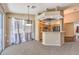 Open floor plan with a breakfast bar connecting the kitchen and dining area featuring wood cabinets at 201 Teller St, Henderson, NV 89074