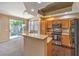 Kitchen and dining area with breakfast bar, stainless steel appliances, and sliding glass doors to the backyard at 201 Teller St, Henderson, NV 89074