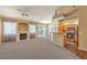 Open-concept living room with a fireplace, modern kitchen, and a sliding glass door to the patio at 201 Teller St, Henderson, NV 89074