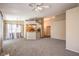 Bright, carpeted living room with an open layout to the kitchen and dining area with backyard access at 201 Teller St, Henderson, NV 89074
