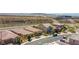 A high angle view showing houses on a suburban street surrounded by desert terrain and mountain range at 2207 Valdina St, Henderson, NV 89044
