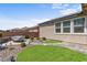 Landscaped backyard featuring a rock garden, faux grass, and low maintenance plantings at 2207 Valdina St, Henderson, NV 89044