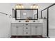 Bathroom featuring double sinks, a large mirror, and a modern shower with a glass door at 2207 Valdina St, Henderson, NV 89044