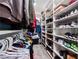 Well-organized walk-in closet featuring shelving for shoes and clothes, and hanging rods for optimal storage at 2207 Valdina St, Henderson, NV 89044