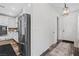 Hallway view with stainless steel refrigerator on the left and view of the entryway at 2207 Valdina St, Henderson, NV 89044