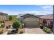 Charming single-story home with a well-maintained yard, desert landscaping, and a two-car garage at 2207 Valdina St, Henderson, NV 89044