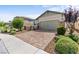 Inviting home with a brick driveway, lush landscaping, and a two-car garage at 2207 Valdina St, Henderson, NV 89044