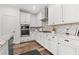 Modern kitchen with white cabinets, granite countertops, stainless appliances, and hardwood floors at 2207 Valdina St, Henderson, NV 89044