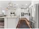 Contemporary kitchen featuring white cabinets, granite countertops, stainless steel appliances, and hardwood floors at 2207 Valdina St, Henderson, NV 89044