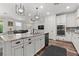 Well-lit kitchen with stainless appliances, an island with granite countertops, and hardwood flooring at 2207 Valdina St, Henderson, NV 89044