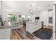 Open-concept kitchen with stainless appliances, an island with granite countertops, and hardwood flooring at 2207 Valdina St, Henderson, NV 89044