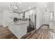 Modern kitchen with white cabinetry, stainless steel appliances, granite countertops, and hardwood floors at 2207 Valdina St, Henderson, NV 89044