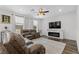 Comfortable living room with plush seating, a modern fireplace, and wood-look flooring at 2207 Valdina St, Henderson, NV 89044