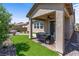 Relaxing covered patio with brick floors overlooking lush backyard landscaping and desert plants at 2207 Valdina St, Henderson, NV 89044