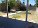 Backyard with an overgrown lawn and a partially covered patio at 2211 Chipplegate Way, North Las Vegas, NV 89032