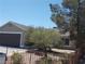 Exterior view of home with desert landscaping, and a spacious two-car garage at 2211 Chipplegate Way, North Las Vegas, NV 89032