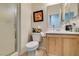 Well-lit bathroom with white fixtures, a vanity, and glass shower at 2418 Brockton Way, Henderson, NV 89074