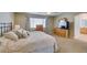 Inviting bedroom featuring natural light, an en-suite bathroom, and soft carpet at 2418 Brockton Way, Henderson, NV 89074
