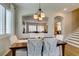 Elegant dining room with hardwood floors, stylish lighting, and open layout perfect for entertaining guests at 2418 Brockton Way, Henderson, NV 89074