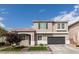 Charming two-story home featuring a well-manicured front yard, two-car garage, and neutral color palette at 2418 Brockton Way, Henderson, NV 89074