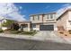 Inviting two-story home featuring a well-manicured lawn, attached two car garage, and neutral color scheme at 2418 Brockton Way, Henderson, NV 89074