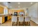 Well-lit kitchen features a breakfast bar with seating, stainless appliances, and hardwood floors at 2418 Brockton Way, Henderson, NV 89074