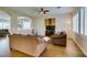 Comfortable living room with hardwood floors, ceiling fan, and large windows with plantation shutters at 2418 Brockton Way, Henderson, NV 89074
