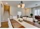 Hardwood floored living area with staircase access, adjacent to the dining room at 2418 Brockton Way, Henderson, NV 89074