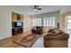 Spacious living room with hardwood floors, built-in cabinetry, and plantation shutters for relaxed, comfortable living at 2418 Brockton Way, Henderson, NV 89074