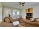 Cozy living room featuring hardwood floors, ceiling fan, and open view into the adjacent sitting room at 2418 Brockton Way, Henderson, NV 89074