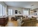 Elegant living room featuring hardwood floors, plush sofas, and bright, shuttered windows at 2418 Brockton Way, Henderson, NV 89074