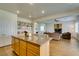 Open concept living room and kitchen featuring hardwood floors and stainless steel appliances at 2418 Brockton Way, Henderson, NV 89074