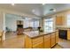 Open concept living room and kitchen with hardwood floors, natural light, and backyard access at 2418 Brockton Way, Henderson, NV 89074