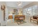 Bright bedroom with large window, wooden bed frame, and comfortable seating area at 2537 Nashira St, Henderson, NV 89044