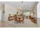 Open-concept dining area with elegant chandelier and view into the bright living room at 2537 Nashira St, Henderson, NV 89044