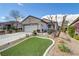 Charming home with a well-manicured front yard, featuring a lush green lawn, desert landscaping, and inviting curb appeal at 2537 Nashira St, Henderson, NV 89044