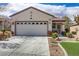 Home exterior with a large garage, nice driveway, and appealing desert landscaping at 2537 Nashira St, Henderson, NV 89044
