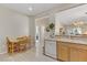 Cozy eat-in kitchen with wood table and chairs, featuring light wood flooring and white appliances at 2537 Nashira St, Henderson, NV 89044