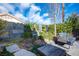 Secluded backyard with peaceful seating area, a tranquil water feature, lush greenery, and privacy fencing at 340 Autumn Palace Ct, Las Vegas, NV 89144