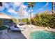 Tranquil backyard featuring a pool, lounge chairs, lush greenery, and ample space for outdoor relaxation at 340 Autumn Palace Ct, Las Vegas, NV 89144