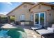 Inviting outdoor living area featuring a pool, built-in grill, lounge chairs, and access to the home's interior at 340 Autumn Palace Ct, Las Vegas, NV 89144