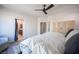 Spacious bedroom featuring a ceiling fan, French doors, a glimpse of the bathroom and a closet at 340 Autumn Palace Ct, Las Vegas, NV 89144
