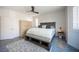 Bedroom showcasing a gray fabric bed frame, a neutral geometric rug and a wooden dresser at 340 Autumn Palace Ct, Las Vegas, NV 89144