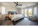 Bright bedroom with modern ceiling fan, gray accent rug, and French doors to outdoor patio at 340 Autumn Palace Ct, Las Vegas, NV 89144