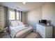 Stylish bedroom featuring modern furniture, a grey accent wall, and natural light from windows at 340 Autumn Palace Ct, Las Vegas, NV 89144