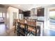 Stylish kitchen featuring dark cabinetry, stainless steel appliances, and bar stool seating at the island at 340 Autumn Palace Ct, Las Vegas, NV 89144