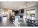 Modern kitchen with stainless steel appliances, a center island, and an adjacent breakfast area with views of the pool at 340 Autumn Palace Ct, Las Vegas, NV 89144