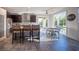 Bright kitchen with a stainless steel refrigerator, counter seating, and adjacent breakfast nook with patio access at 340 Autumn Palace Ct, Las Vegas, NV 89144